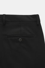 Close-up rear view of Briglia 1949 Wool pants 'Naviglio' black, showing fine twill virgin wool, buttoned back pocket, waistband, and belt loops. Soft touch, slightly elastic, Regular Fit, tapered design with zipper, button, French pockets, and small watch