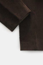 Hiltl Corduroy pants 'Parma' dark brown shown from a close-up side angle, corduroy made of cotton with soft touch, regular fit, slightly tapered, zip fly and waistband hook, French pockets, back pockets with button.