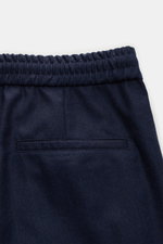 Brunello Cucinelli Wool jogger pants 'Leisure Fit' navy shown from above, featuring pure virgin wool, smooth feel, leisure fit, tapered cut, high waist, short cut, partially elasticated waistband with drawstring, zip and hook fastener, double pleat, Frenc