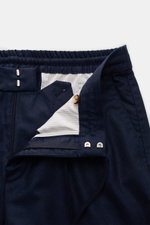 Close-up front view of Brunello Cucinelli Wool jogger pants 'Leisure Fit' navy, showing zip, hook fastener, button, elasticated waistband with drawstring, French pockets, double pleat, high waist, tapered cut, short cut, pure virgin wool, smooth feel, lei