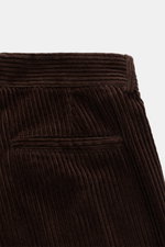 Close-up rear view of Doppiaa Corduroy pants 'Aantioco' dark brown in wide wale cotton corduroy with hip pocket, soft texture, single pleat.