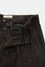 Close-up front view of Ami Paris Cordhose anthrazit in dense cotton corduroy with button fly, showing waistband and texture details. <p>Mit lässiger Eleganz und französischem Esprit verleiht diese Karottenhose von AMI PARIS jedem Auftritt subtile Raffines