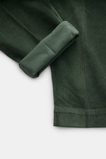 04651/ A trip in a bag Cordhose grün, close-up von Bein mit umgeschlagenem Saum, garment dyed Cord aus Baumwolle und Modal, Slim Fit, knöchellang, mit Stretch.