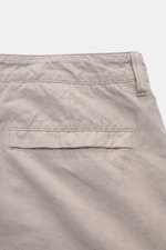 Stone Island Cargo pants 'Ghost Piece' beige shown from the rear close-up, featuring cotton-linen blend, lightweight texture, garment-dyed, regular fit, straight cut, waistband with button and zip, side seam pockets, patch cargo pockets with flap and snap