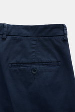 Back close-up view of 04651/ A trip in a bag Chinos navy, made of cotton twill, slightly elasticated fabric, slightly robust to touch, with a tapered fit, regular thigh width, ankle length, slightly tapered cut, zip and waist button, French pockets, small