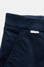Close-up top view of the waistband and pocket area of 04651/ A trip in a bag Chinos navy made of cotton twill. Features slightly elasticated, slightly robust fabric, tapered fit with regular thigh width, ankle length, slight tapered cut, zip and waist but