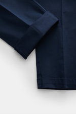 Close-up image of the ankle area of 04651/ A trip in a bag Chinos navy, photographed from a top-down perspective, showing cotton twill fabric with slightly elasticated, slightly robust texture, tapered fit, regular thigh width, ankle length, slightly tape