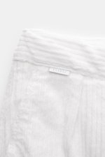 Nahaufnahme der Bundpartie der 04651/ A trip in a bag Cord-Cargohose offwhite aus Breitcord mit weichem Griff, Teilstretch, Tunnelzug, Reißverschluss und Weblabel.