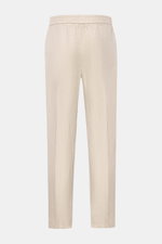 Rear view of 04651/ A trip in a bag Leinen-Jogpants 'Linen Pants' beige, pure linen tapered fit pants with elastic waist, French pockets, and back patch pocket, perfect for warm days, ideal summer essential for travel or office.