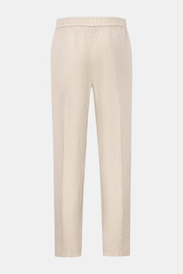 Rear view of 04651/ A trip in a bag Leinen-Jogpants 'Linen Pants' beige, pure linen tapered fit pants with elastic waist, French pockets, and back patch pocket, perfect for warm days, ideal summer essential for travel or office.