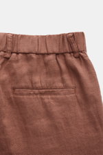 Close-up rear view of 04651/ A trip in a bag Linen jogger pants 'Linen Pants' rust brown, showing pure linen fabric, elasticated waistband, jetted back pocket, and signature texture. 

Description: <p>Perfect for warm days: These linen jogger pants by 046