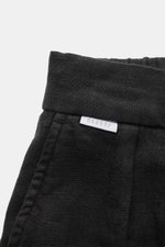 Close-up front top view of 04651/ A trip in a bag Linen jogger pants 'Linen Pants' black showing signature linen texture, waistband, and small woven label.

<p>Perfect for warm days: These linen jogger pants by 04651/ A TRIP IN A BAG are the ideal summer 