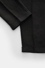 Close-up front view of 04651/ A trip in a bag Linen jogger pants 'Linen Pants' black showing pure linen fabric with signature texture, regular fit, short tapered cut, cuffed hems.

<p>Perfect for warm days: These linen jogger pants by 04651/ A TRIP IN A B