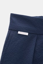 Close-up front top view of 04651/ A trip in a bag Seersucker trousers 'Technical Seersucker' navy showing seersucker microfiber fabric with fine texture, robust material, tapered fit, regular thigh width, ankle length, zip and waist button, double pleat, 