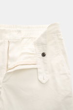 Close-up front view of 04651/ A trip in a bag Cotton jogger pants "Flex Light" cream showing zip, waist button, elasticated waistband, and pockets.