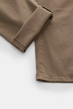 Close-up angled view of Jacob Cohen Cotton trousers 'Nick' grey-brown folded at the cuff, showing pure cotton fabric, elasticated, soft feel, slim fit, tapered cut, tonal stitching, and detailed seams. Modern luxury for everyday wear – why not? The five-p