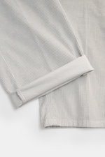 Close-up top-down view of Marco Pescarolo Corduroy Pants 'Dieci' Light Grey showing light grey cotton corduroy fabric with soft texture and tapered, ankle-length leg cuffs. Versatile, the corduroy pants 'Dieci' by MARCO PESCAROLO are made of slightly stre