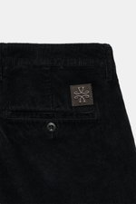 Close-up rear view of Jacob Cohen Corduroy Pants 'Bobby' black, showing precise Italian craftsmanship in soft cotton blend with logo patch.