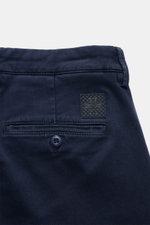 Jacob Cohen Pants 'Bobby' navy shown from the back close-up, highlighting soft twill cotton-lyocell fabric with elastic quality, slim tapered fit, buttoned welted back pockets, and tonal leather patch for modern luxury and comfort. 

<p>Embrace modern lux