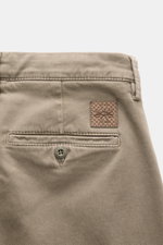 Close-up rear view of Jacob Cohen Pants 'Bobby' taupe showing soft cotton-lyocell twill, elastic slim fit with back pockets, button, and leather patch. Opt for modern luxury in everyday life: The slim-cut pants 'Bobby' by JACOB COHEN impress with soft twi