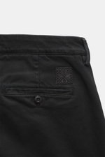 Close-up rear view of Jacob Cohen Pants 'Bobby' black showing soft cotton-lyocell twill fabric, tapered slim fit, buttoned back pocket, and tonal leather patch. Opt for modern luxury in everyday life with these slim-cut pants featuring elastic quality, so