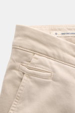 Close-up shot from above of Jacob Cohen Pants 'Bobby' sand, showing soft twill cotton and lyocell fabric, slim fit with tapered cut, French pockets, piped coin pocket, back button pockets, zipper and waistband button, and tonal leather patch, highlighting
