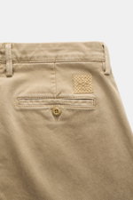Jacob Cohen Pants 'Bobby' beige shown from the back top close-up, featuring soft cotton-lyocell twill, slim fit, tapered cut, buttoned back pocket, and leather patch. Rely on modern luxury in everyday life: The slim-cut pants 'Bobby' by JACOB COHEN impres