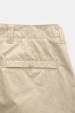 Stone Island Cargo Pants 'Ghost Piece' sand shown from the back waist close-up, made of cotton poplin with welt pocket and branded button. Monochrome all-rounder for casual looks: these cargo pants made of robust cotton poplin from STONE ISLAND are part o