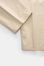 Close-up detail of the hem and fabric texture of Stone Island Cargo Pants 'Ghost Piece' sand, photographed from a top-down perspective.

Description: <p>Monochrome all-rounder for casual looks: these cargo pants made of robust cotton poplin from STONE ISL