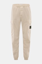 Stone Island Cargo Jogpants beige front view, elastic organic cotton, tapered fit, cargo pockets, zip fly, compass badge, elastic waistband and cuffs.