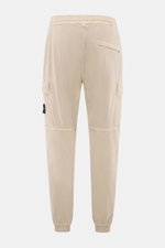 Stone Island Cargo Jogpants beige shown from the back, tapered fit with elastic waistband, cargo and concealed zipper pockets, elastic cuffs.