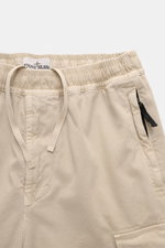 Close-up front view of Stone Island Cargo Jogpants beige, showing elastic waistband with internal drawstring, zip fly, and zipper pocket. For everyone who wants to combine function and style: These cargo jogpants by STONE ISLAND are inspired by classic ut
