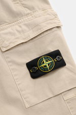 Stone Island Cargo Jogpants beige close-up from above showing the soft organic cotton fabric, cargo pocket with flap, and compass badge.