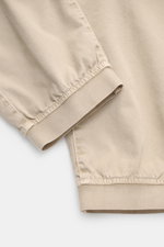 Stone Island Cargo Jogpants beige shown close-up from the side, highlighting elastic leg cuffs and soft organic cotton fabric with a garment-dyed finish. For everyone who wants to combine function and style: These cargo jogpants by STONE ISLAND are inspir