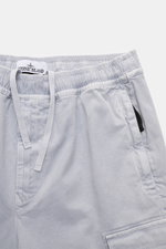 Stone Island Cargo Jogpants smoky blue shown from a top-front close-up view, featuring elastic waistband with drawstring, zip fly, concealed zipper pockets, cargo pockets, typical compass badge, darts at knee level, back pocket with snap button, elastic l