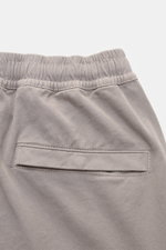 Close-up rear view of Stone Island Cargo Jogpants grey, showing elastic waistband and back pocket with snap button, made from soft elastic organic cotton.  

Description: For everyone who wants to combine function and style: These cargo jogpants by STONE 