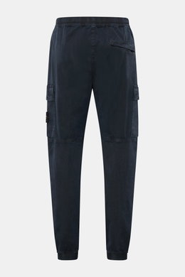 Rear view of Stone Island Cargo Jogpants navy, tapered fit cargo jogpants in garment dyed elastic organic cotton with concealed zip and cargo pockets, elastic cuffs, and compass badge.