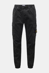 Front view of Stone Island Cargo Jogpants black, tapered fit with elastic waistband, drawstring, zip fly, cargo pockets, and compass badge, made from elastic organic cotton with soft touch, garment dyed, short cut, with concealed zipper pockets, darts at 