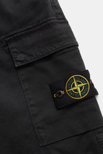 Close-up side view of Stone Island Cargo Jogpants black showing the cargo pocket with the iconic compass badge, made of elastic, garment-dyed organic cotton with soft touch and stretch.