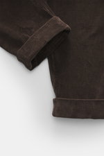 Berwich Corduroy pants 'Chiaia' dark brown shown close-up from a top-down perspective, highlighting the soft, slightly elastic cotton fabric with a fixed hem turn-up and distinctive corduroy texture. The trousers feature a tapered fit, regular thigh width