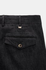 Close-up rear view of the waistband and back pocket of PT Torino Jeans 'Rebel Fit' dark navy melange, showing fine cotton-cashmere blend fabric with a slightly textured, elastic quality, featuring a small metal "PT" initial on the belt loop, a back pocket