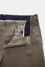 PT Torino Chino 'Slim Fit' gray viewed from above, showing open zipper, waistband buttons, cotton twill with light stretch, soft feel, tapered fit, French pockets, small watch pocket, and welt back pockets with button. For these chinos, PT TORINO selects 