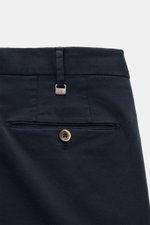 Close-up rear view of PT Torino Chino 'Slim Fit' navy in soft cotton twill with light stretch, showing waistband, belt loop with PT metal detail, piped back pocket with button. For this chino, PT TORINO chooses classic cotton twill in a soft quality and a