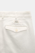 PT Torino Cotton Trousers 'Carrot Fit' offwhite shown from the back waist, featuring cotton twill, double pleat, flap pocket, and PT Torino label.