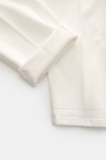 Close-up front view of PT Torino Cotton Trousers 'Carrot Fit' offwhite showing the short cut, folded cuff, and textured cotton twill fabric with pleats.