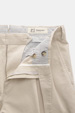 Close-up front view of the PT Torino Chino 'Hamptons' sand pants showing twill pure cotton fabric, soft touch, tapered fit, regular thigh width, ankle length, very slim tapering, zipper and waistband buttons, extended button tab, small watch pocket, doubl