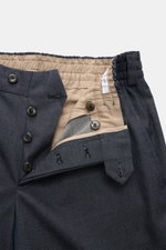 Close-up front view of PT Torino Trousers 'The Rebel' grey blue melange showing button fly, elastic waistband, and beige inner lining, made of stretch twill cotton and virgin wool.  

Description:  
<p>Comfort meets style: The 'The Rebel' trousers from PT