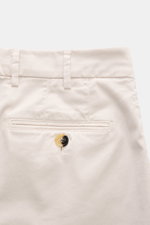 Brunello Cucinelli Chinos 'Italian Fit' cream shown from a close-up top-back view, highlighting the garment-dyed twill, French pockets, small watch pocket, back pocket with button, belt loops, and button detail. These chinos from luxury label BRUNELLO CUC