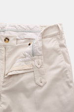 Brunello Cucinelli Chinos 'Italian Fit' cream shown from the front top view with open zipper and button, elasticated cotton twill, soft feel, garment-dyed, regular fit, tapered cut, French pockets, small watch pocket, and back pockets with button.