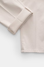 Close-up side and folded cuff view of Brunello Cucinelli Chinos 'Italian Fit' cream in elasticated cotton twill with soft, garment-dyed fabric.